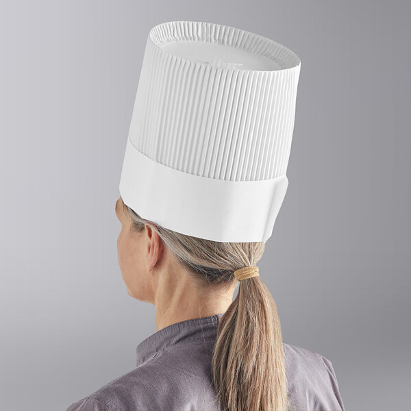 A woman wearing a white Choice disposable chef hat.