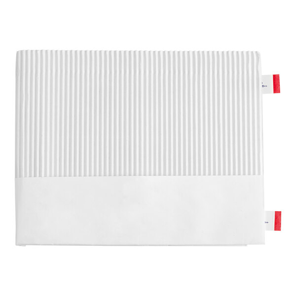 A white rectangular object with red tags.
