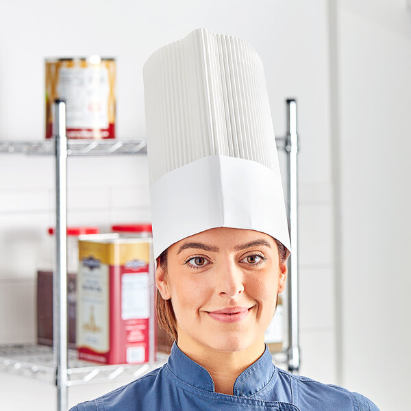 A woman wearing a white Choice disposable chef hat and smiling.