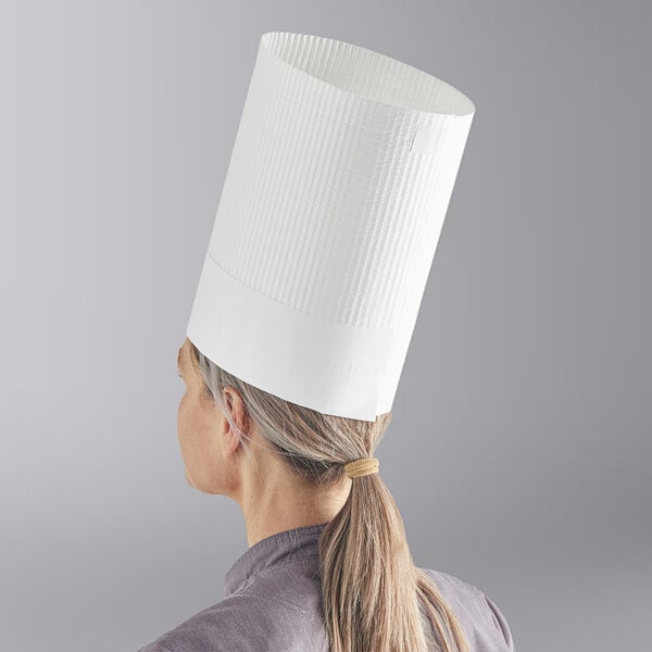 A woman wearing a white Choice disposable chef hat.