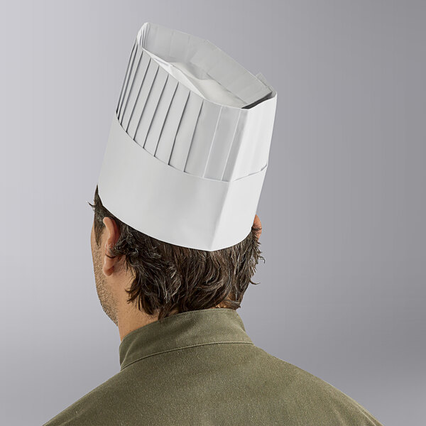 A man wearing a white Choice disposable chef hat.