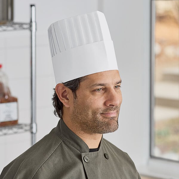 A man wearing a white Choice pleated disposable chef hat.