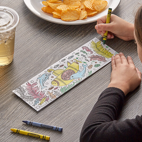 A child coloring an under the sea picture with a yellow crayon.