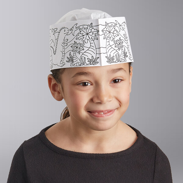 A little girl wearing a Choice Kids Dino coloring paper hat with a dinosaur drawing.