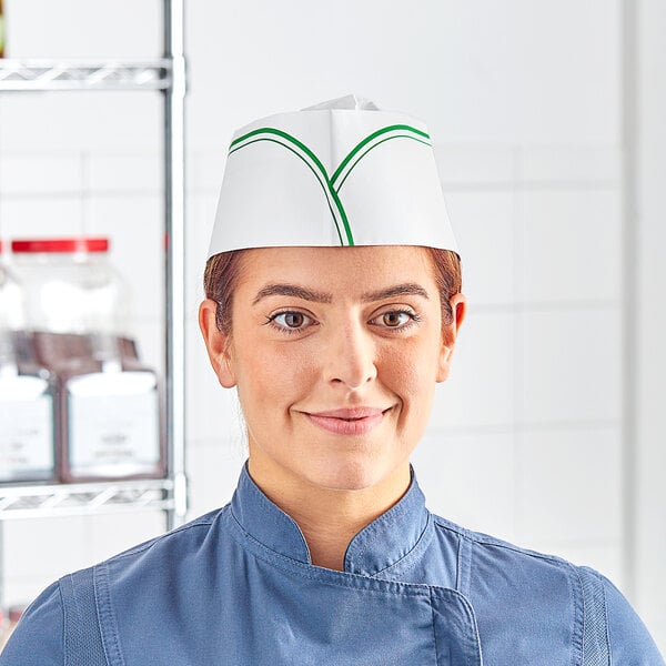 A woman wearing a green striped Choice disposable chef hat.