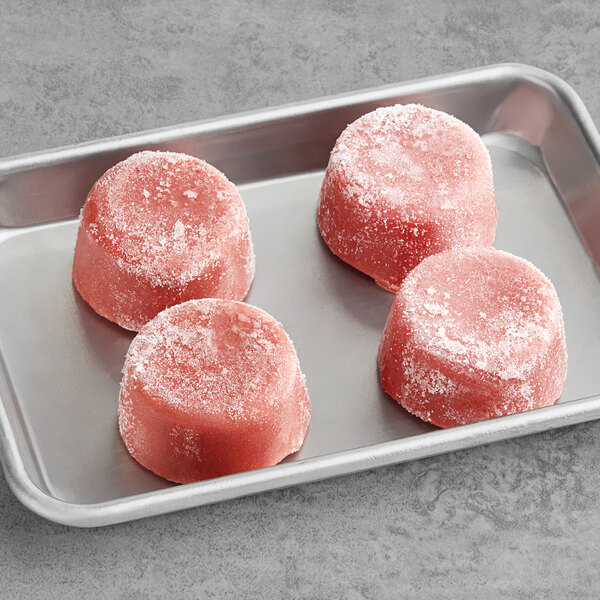 A tray of three pink frozen Blender Bites Smoothie pucks.