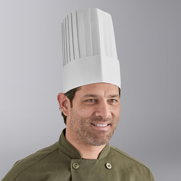 A man wearing a white pleated Choice chef hat.