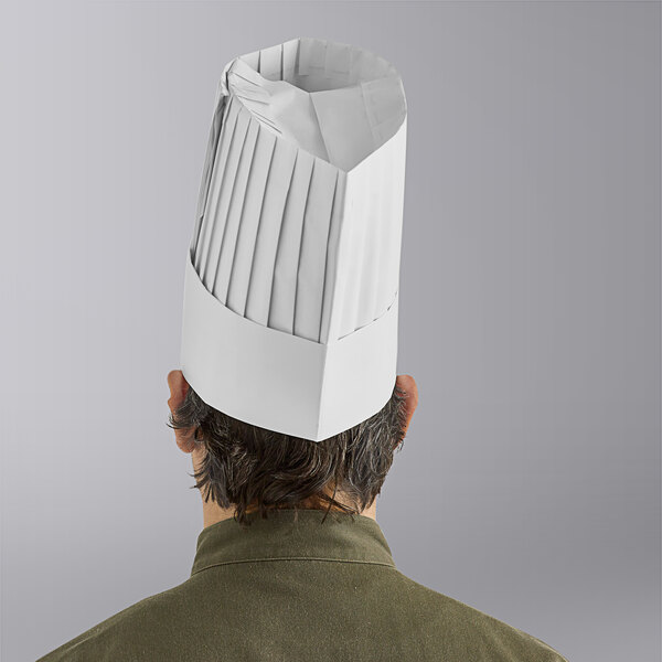 A man wearing a white Choice pleated disposable chef hat.