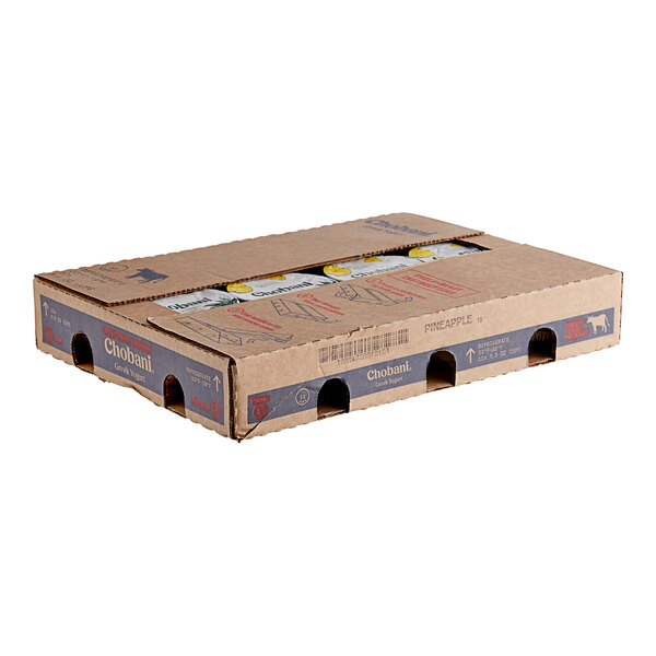 A cardboard box of Chobani Low-Fat Pineapple Greek Yogurt with the lid open.