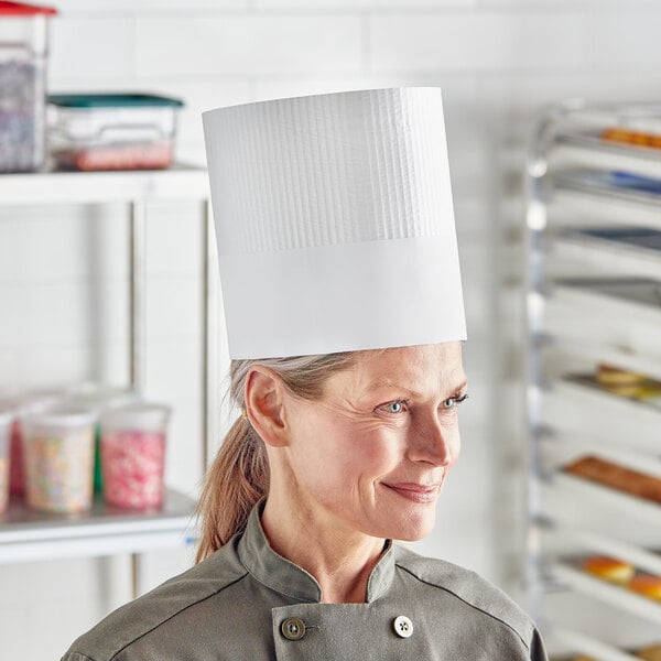 A woman wearing a white Choice disposable chef hat.