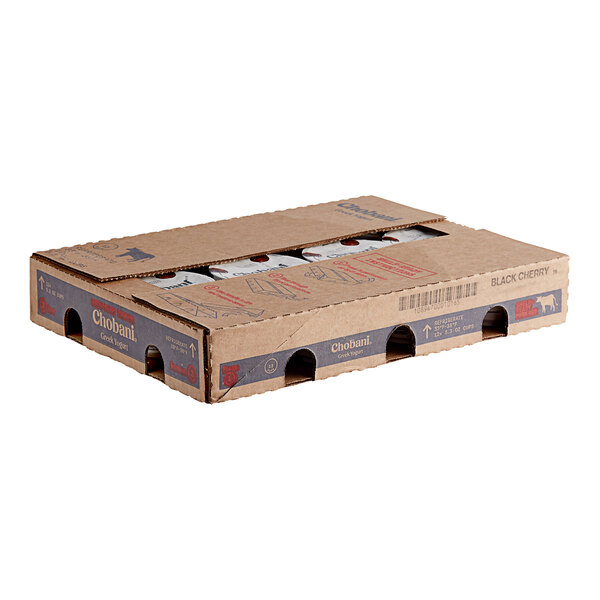 A cardboard box with a couple of discs inside and holes in it.