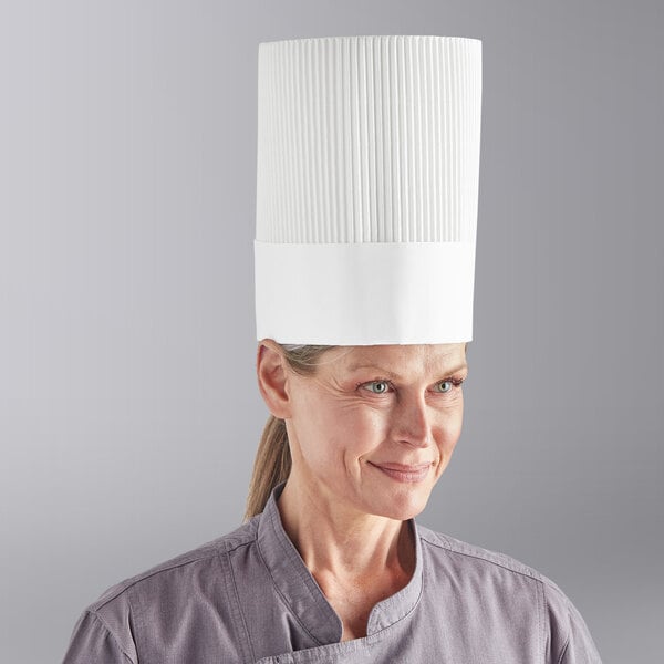 A woman wearing a white Choice disposable chef hat.