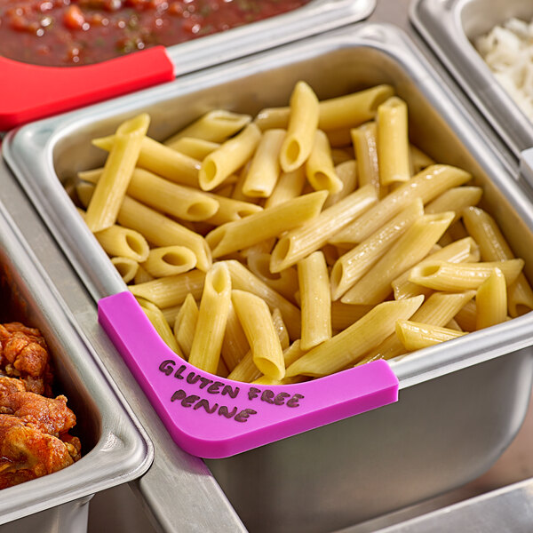 A tray of food with pasta and sauce labeled with a purple Vigor corner label.