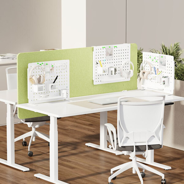 A white desk with a Kantek pegboard divider and a white chair.