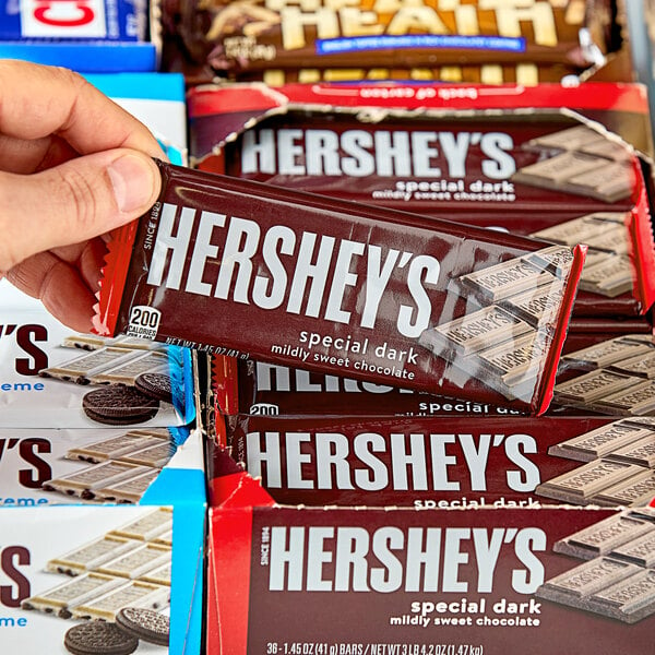 A hand holding a HERSHEY'S Special Dark Chocolate Bar.