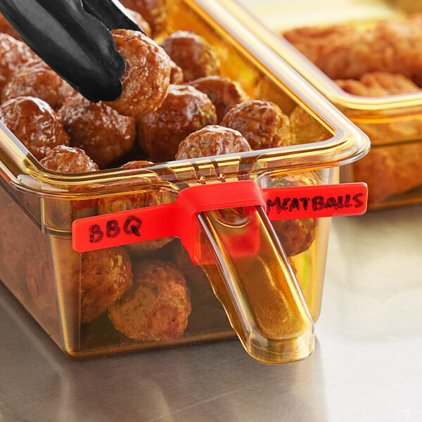 A close up of a Vigor red blank food label on a container of meatballs.