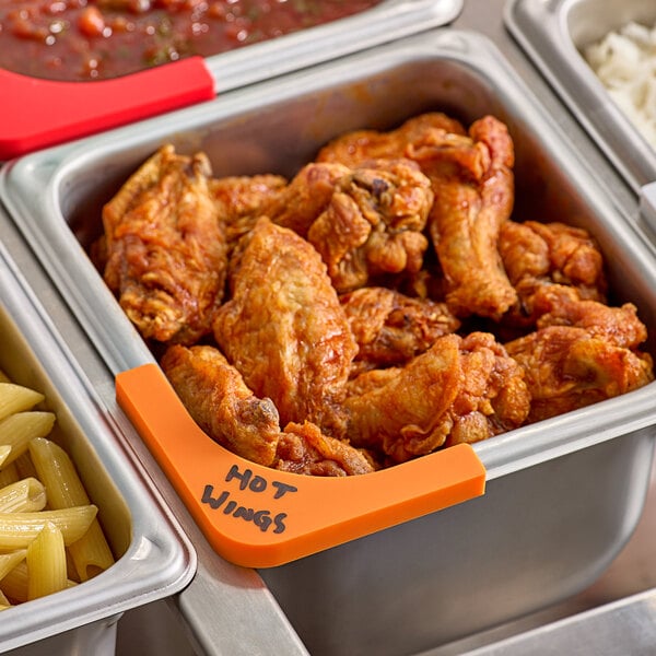 A Vigor orange write-on label on a tray of chicken wings and pasta.