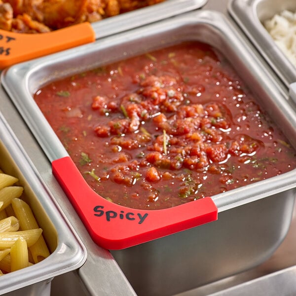 A container of food with a red corner label on the counter.