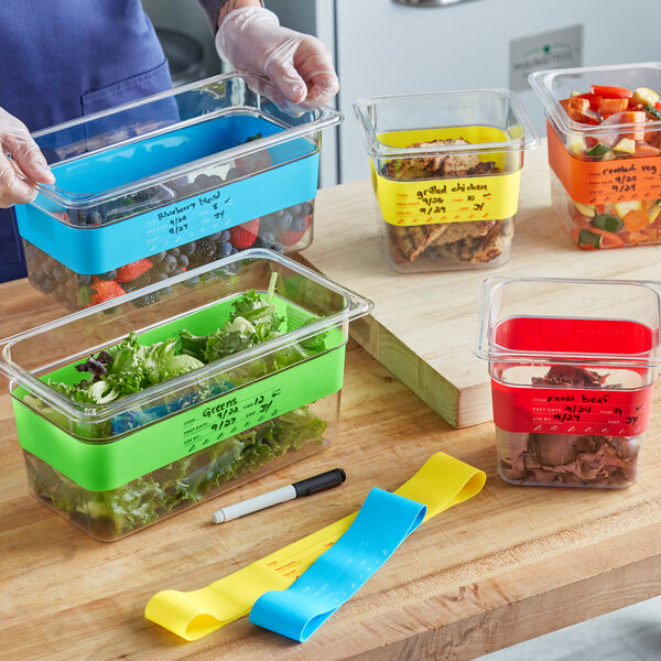 A person labeling food in a plastic container with a red Choice band.