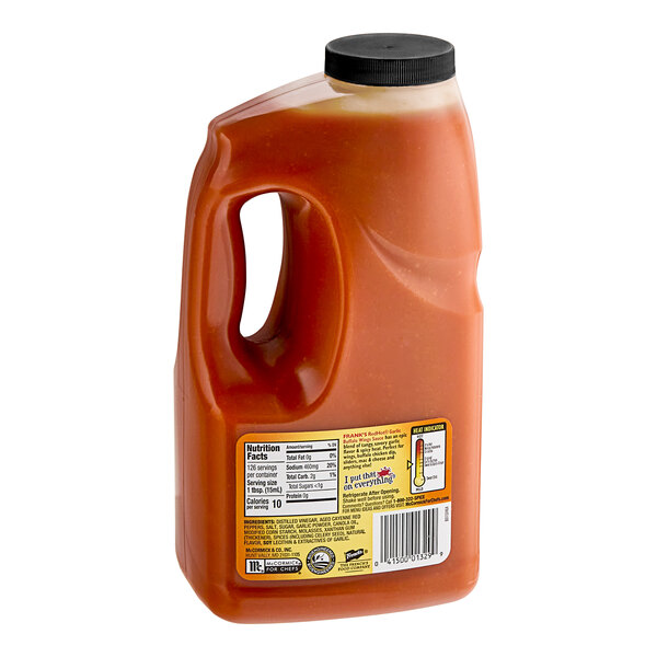 A plastic jug of Frank's RedHot garlic buffalo wing sauce.