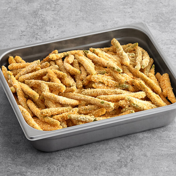 A pan filled with Birds Eye Crispy Green Beans on a table.