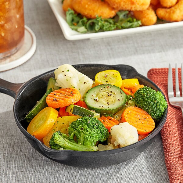 A pan of Birds Eye Normandy Blend mixed vegetables with a fork.