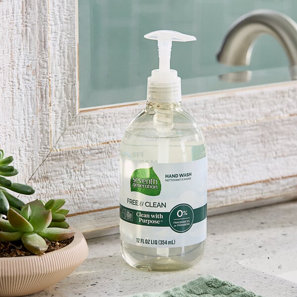 A bottle of Seventh Generation Free & Clear liquid hand soap with a pump on a counter next to a plant.