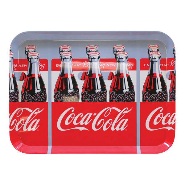 A Tablecraft Coca-Cola tray with six bottles of Coca-Cola on it.