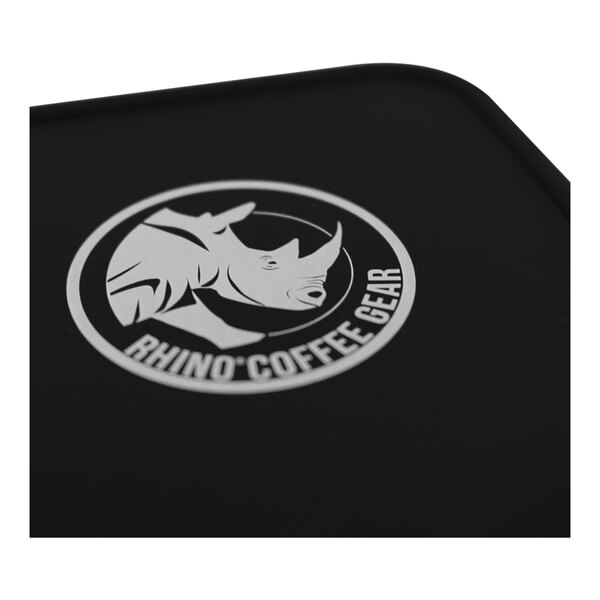 A black Rhino Coffee Gear silicone bench tamper mat on a counter.