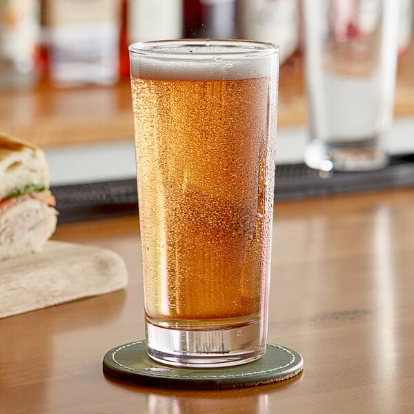 A bag of Endless Harvest blueberry puree on a table with a glass of beer and a sandwich.