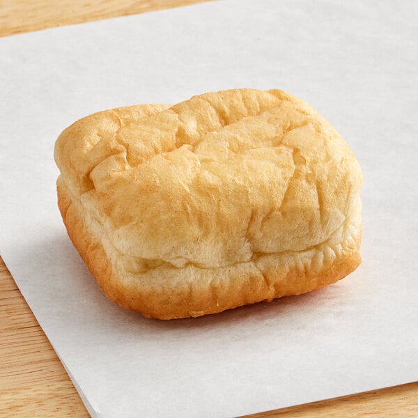 A piece of Brian's Fabulous FryBreads plain beignet on white paper.