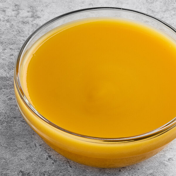 A bowl of mango liquid on a counter.