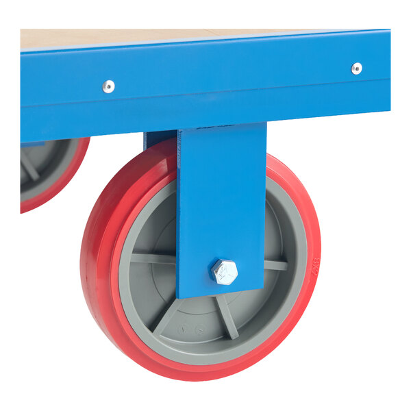 A close-up of a heavy-duty utility cart wheel attached to a blue metal frame.