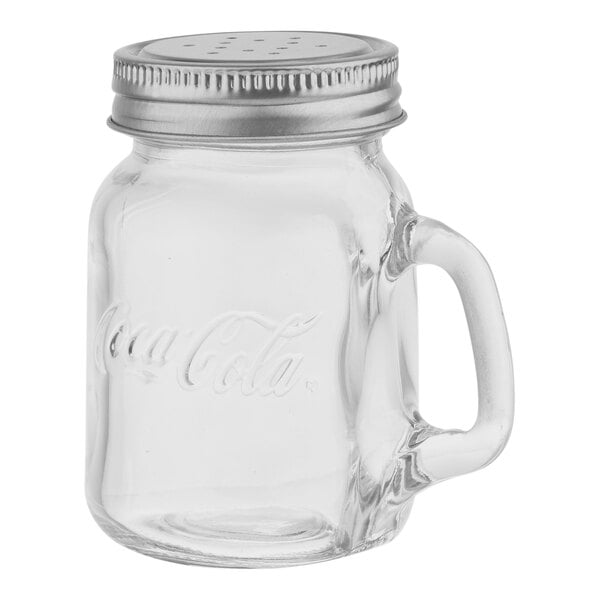 A clear glass Tablecraft Coca-Cola mason jar with a stainless steel lid and handle.