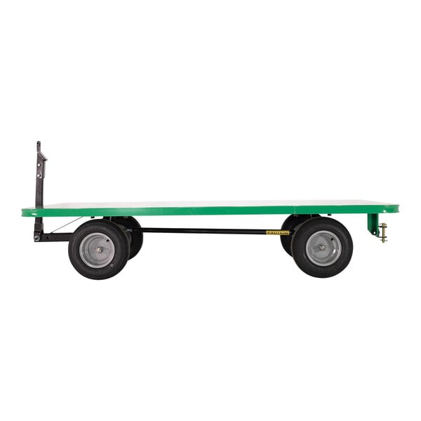 A green and black Valley Craft Quad-Steer trailer with a black and green deck.