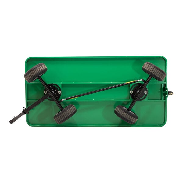A green Valley Craft quad-steer trailer with a black metal deck and black wheels.