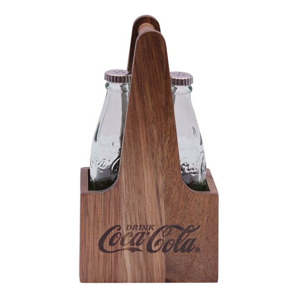 A wooden Tablecraft caddy holding Coca-Cola bottle salt and pepper shakers.