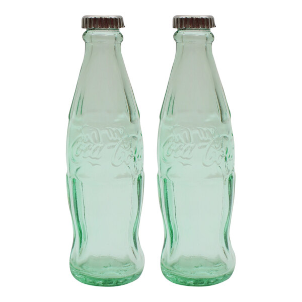 Two green glass Coca-Cola bottles with stainless steel tops.