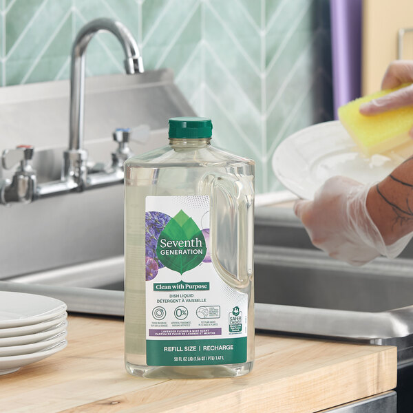A 50 oz. bottle of Seventh Generation Lavender Flower and Mint Dish Liquid placed on a kitchen counter near a sink.