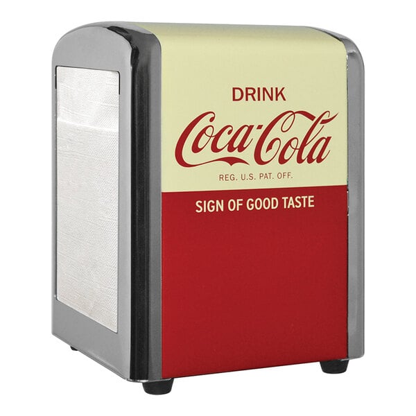 A Tablecraft Coca-Cola napkin dispenser on a countertop with a red and white label.