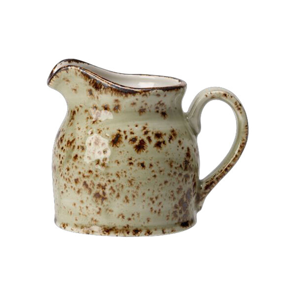 A Steelite Performance Craft green club jug with a handle and brown speckles.