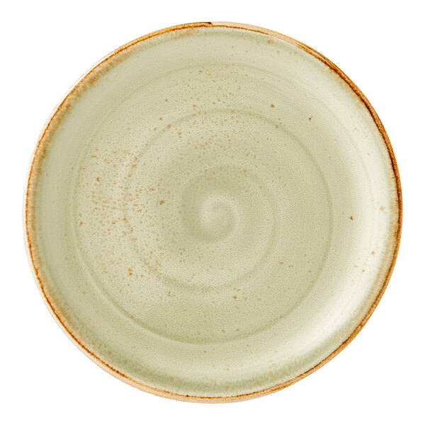 A round, green ceramic coupe plate with a subtle swirl pattern and a slightly rustic, brown-edged rim.