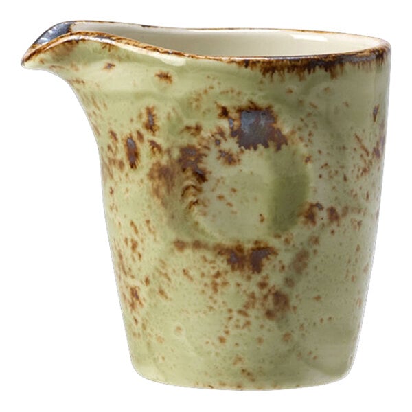 A Steelite green pourer with a brown speckled design on a white surface.