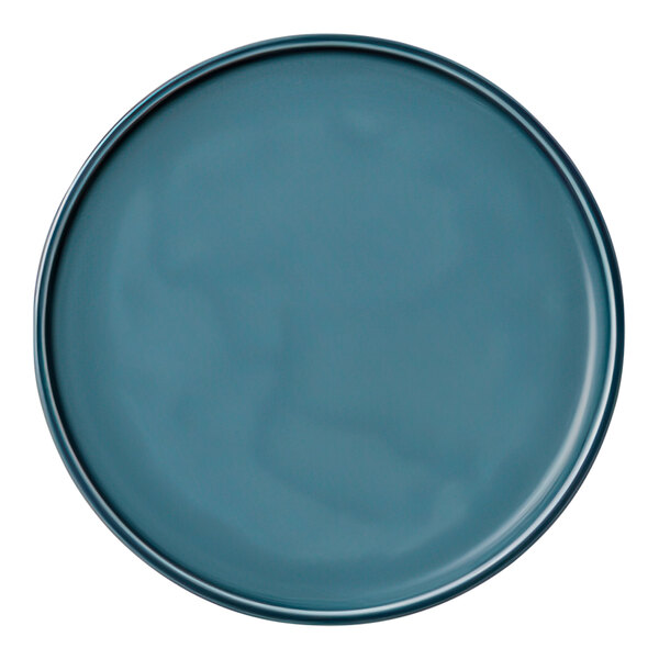 A close-up of a Schonwald Petrol Blue porcelain coupe plate with a rim.