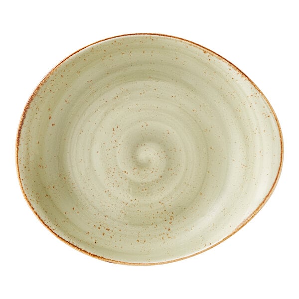 A round, green ceramic bowl with a speckled pattern and a rustic, uneven rim.