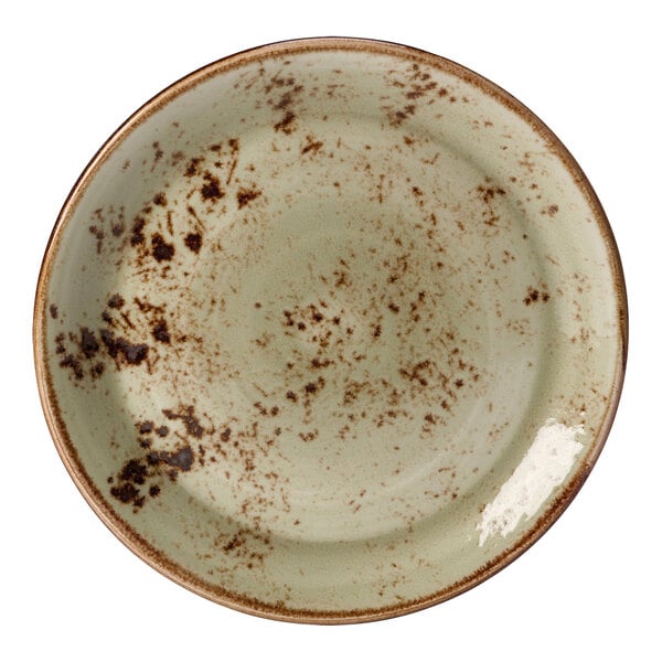 A close up of a green Steelite Performance Craft coupe plate with brown and green spots.