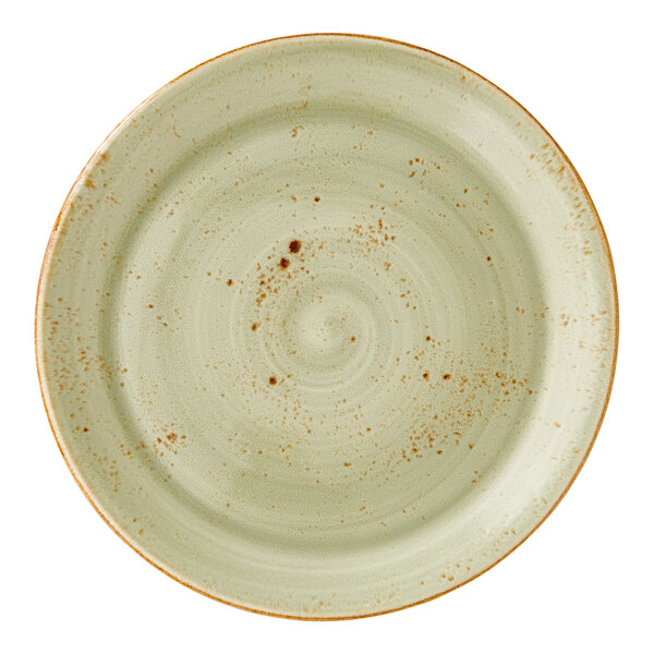 A large green coupe plate with a speckled design and rustic finish.