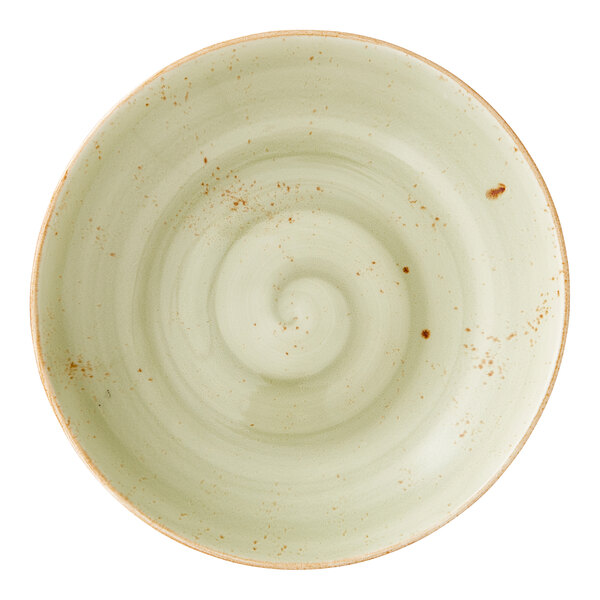 A round, green ceramic coupe bowl with a subtle swirl pattern and rustic speckled accents.
