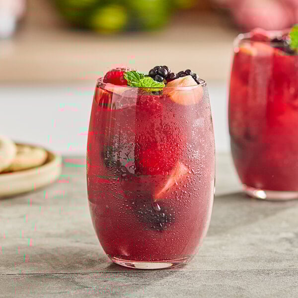 Two glasses of Torani mixed berry puree with fruit in them.