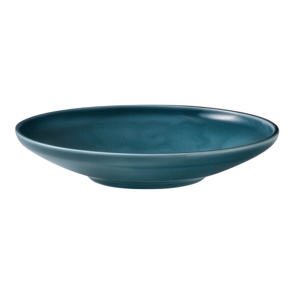 A Schonwald Petrol Blue Porcelain deep coupe plate on a table with a white background.